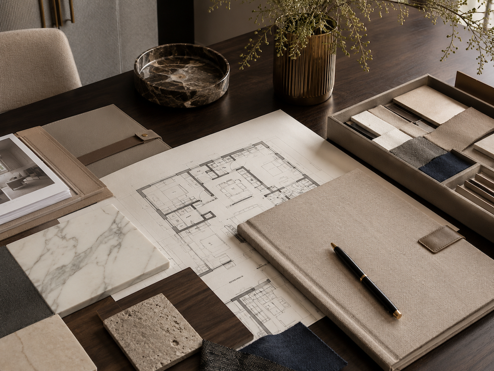 Strategic interior design intake materials with architectural plans, stone, wood, fabric, finish samples, and project documentation